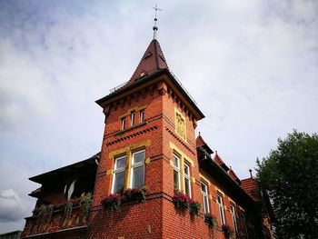 Low angle view of clock tower against sky