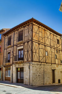 Low angle view of old building against clear blue sky