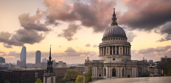 Panoramic view of buildings in city against sky during sunset