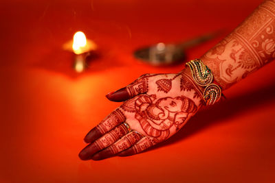 Close-up of woman hand with red light painting