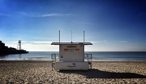 Lifeguard hut at beach against sky