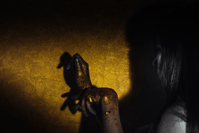 Shadow of man holding woman at night