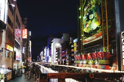 Illuminated street market in city at night