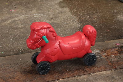 High angle view of red toy car on footpath