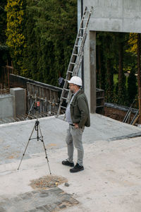 Geodetic works. surveyor engineer using geodetic equipment at construction site. professional