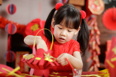 Close-up of cute girl with christmas lights