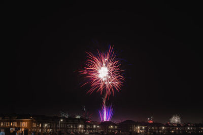 Low angle view of firework display at night