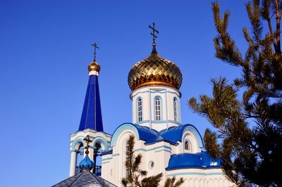 Low angle view of building against clear blue sky