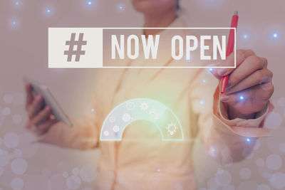 Midsection of woman using mobile phone