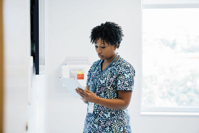 Female doctor using tablet computer while working in hospital