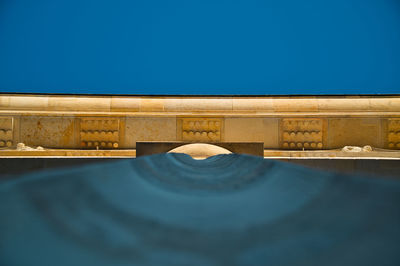 Directly below shot of swimming pool against blue sky