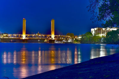 Reflection of illuminated built structure in water