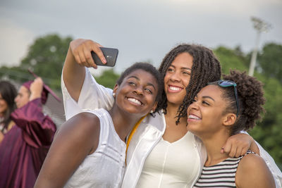 Portrait of smiling young woman using smart phone