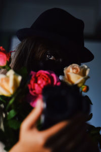 Close-up of woman holding rose at home