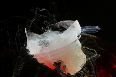 Close-up of ice glass against black background