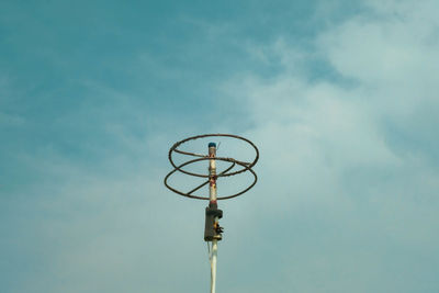 Low angle view of communications tower against sky