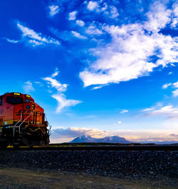 Train on railroad track against sky