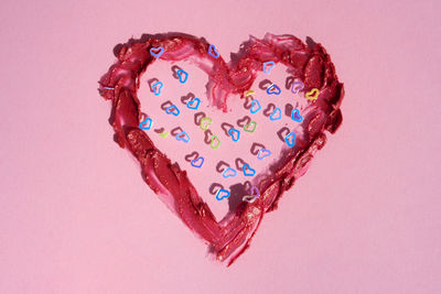 Directly above shot of heart shapes on pink background