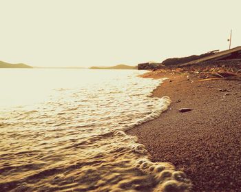 Scenic view of sea against clear sky during sunset