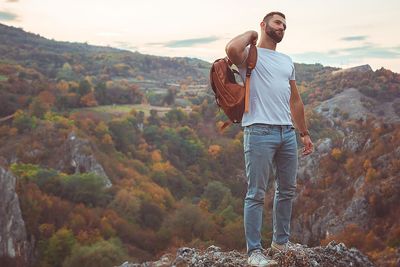 Man standing on rock against mountain