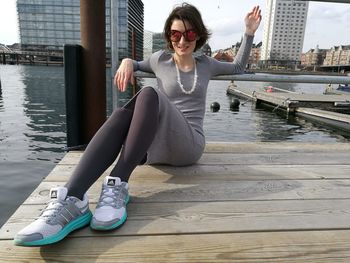 Woman sitting on mobile phone in city