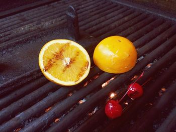 Close-up of lime and cherries on barbecue grill