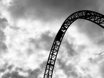 Low angle view of silhouette ferris wheel against sky