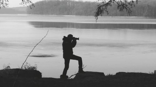 Man photographing lake