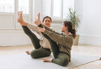 Young woman sitting on floor at home