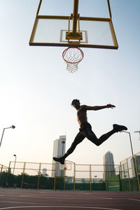 Black man playing basketball game