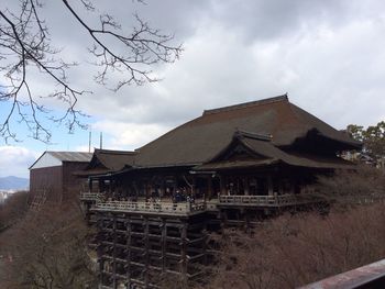 Houses against cloudy sky