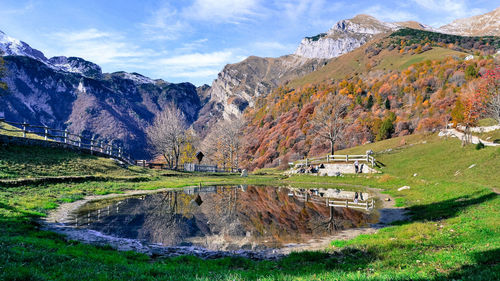 Scenic view of lake and mountains against sky