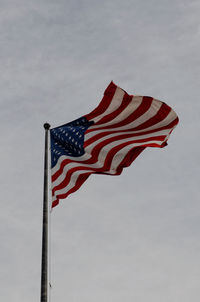 Low angle view of flags flag against sky