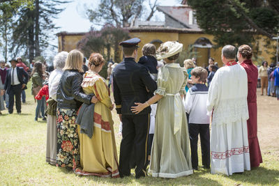 Rear view of people on field