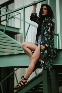 Young woman standing on staircase