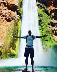 Full length of man on waterfall