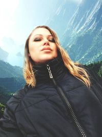 Close-up of beautiful woman standing against sky during winter