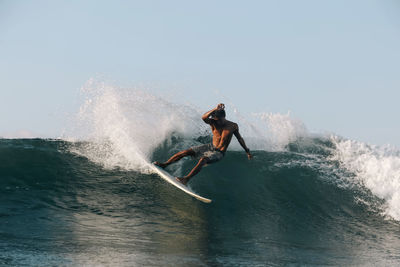 Surfer on a wave, lombok, indonesia