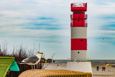 View of lighthouse on beach against sky