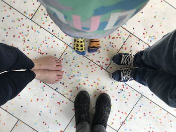 Low section of man standing on tiled floor