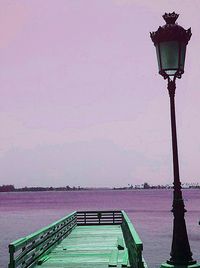 Pier on sea against clear sky