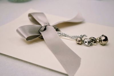 Close-up of envelope with ribbon on table