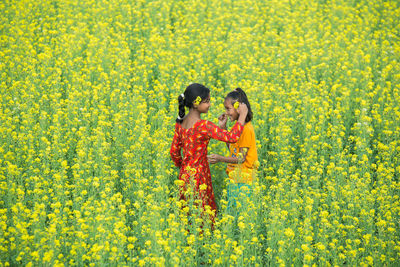 Full length of a woman standing in field