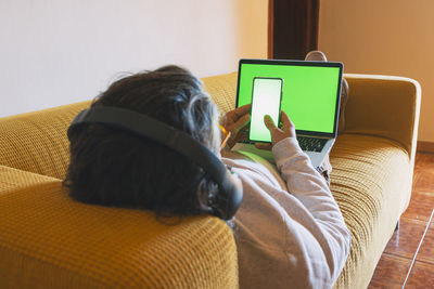 Rear view of woman using mobile phone