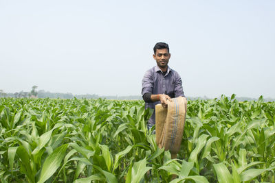 Portrait of young man standing on field