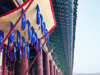 Low angle view of flags hanging against buildings