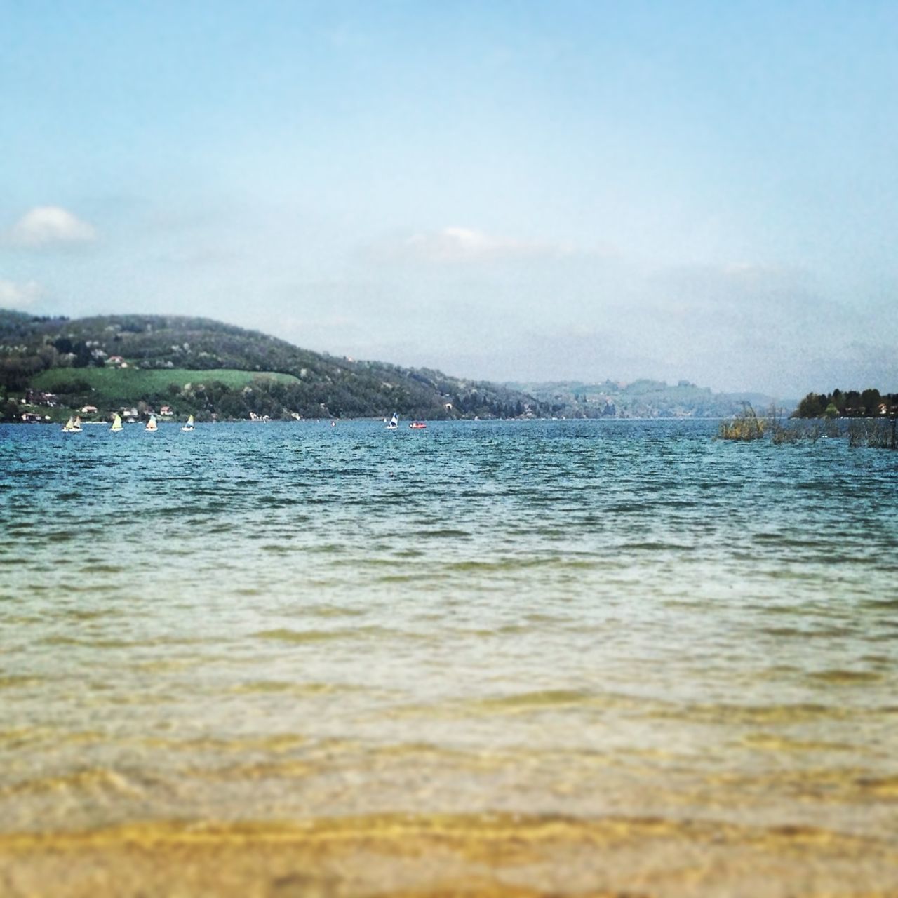 water, sea, mountain, scenics, waterfront, tranquil scene, sky, tranquility, beauty in nature, blue, nature, rippled, idyllic, lake, day, outdoors, no people, beach, mountain range, clear sky