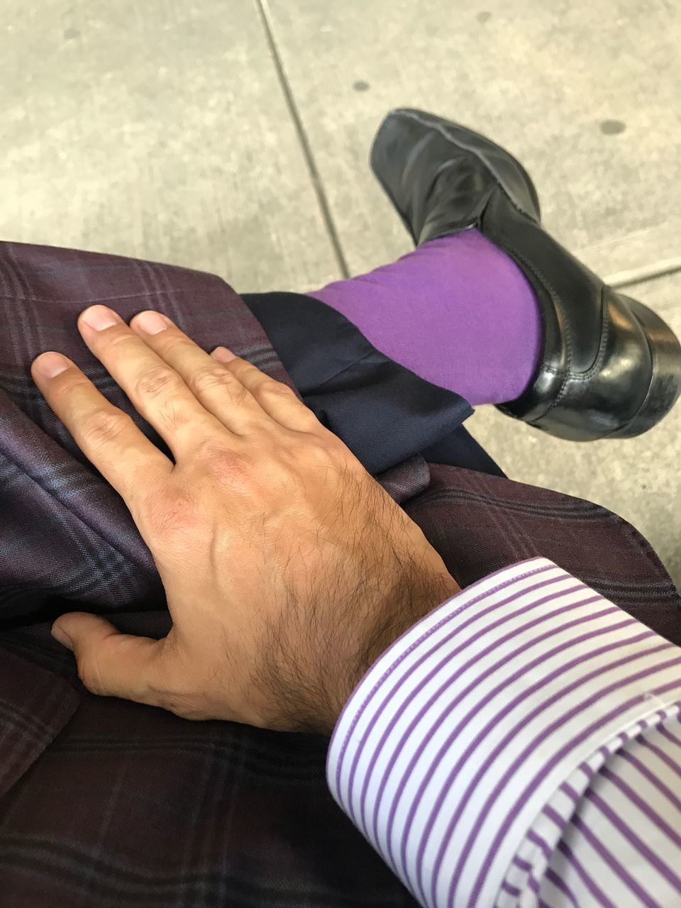 LOW SECTION OF MAN SITTING ON PURPLE