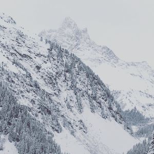 Scenic view of snow covered mountains against sky