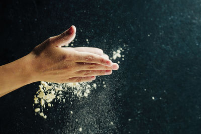 Child preparing pizza dough and clapping flour with hands, home food concept
